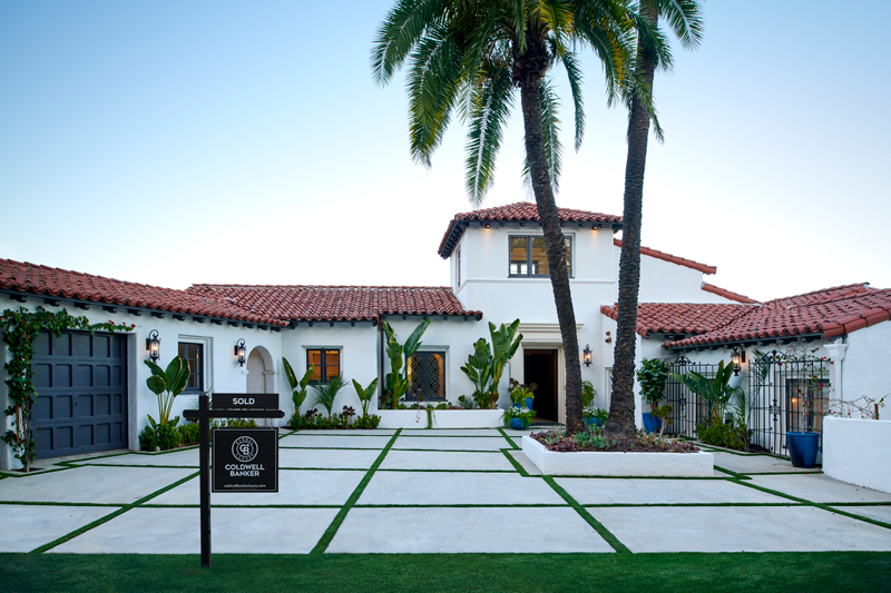 A luxry home with for sale sign